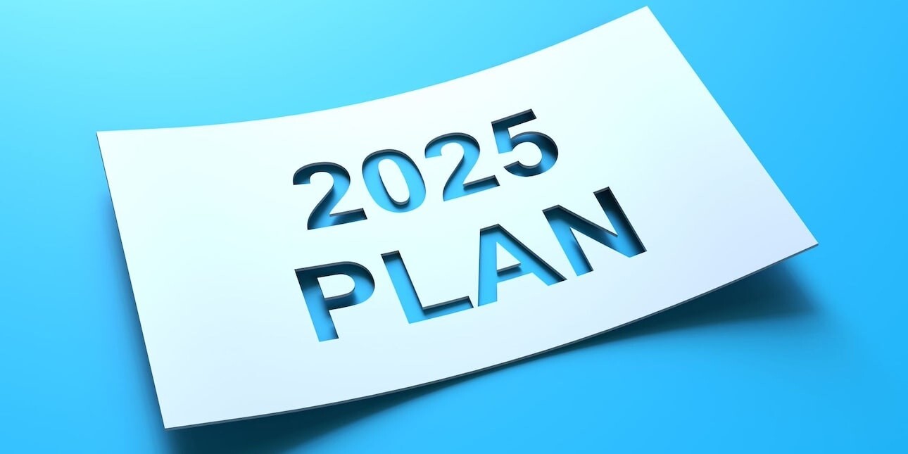 A computer generated image of the words 2025 plan cut out from a piece of white card on a blue background