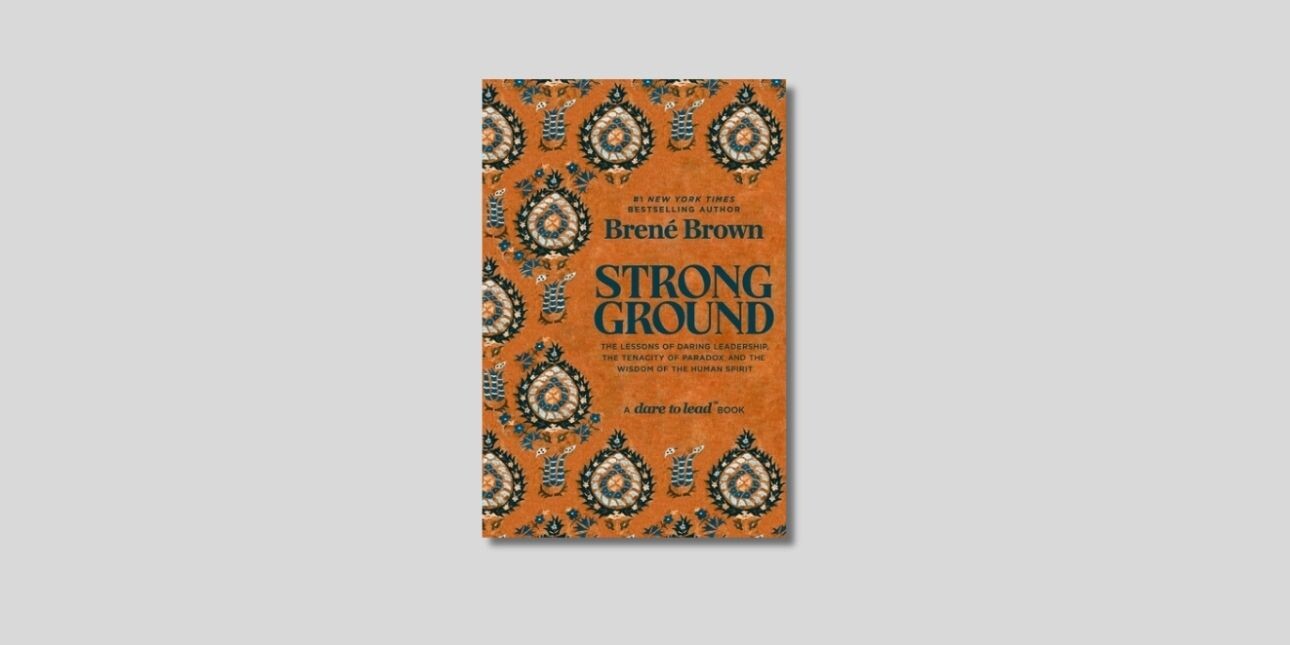 An orange book cover of Bené Brown's Strong Ground.