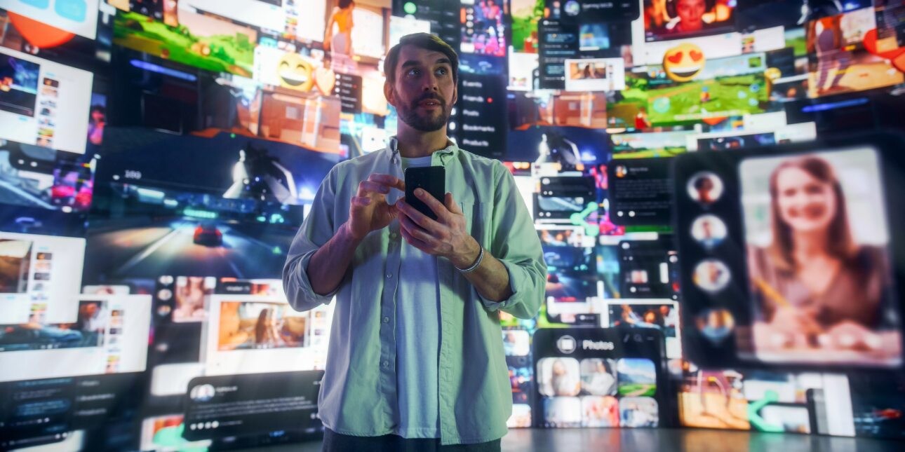 Portrait of a white man using a smartphone surrounded by digital social media interfaces, online Video games, videos and internet content