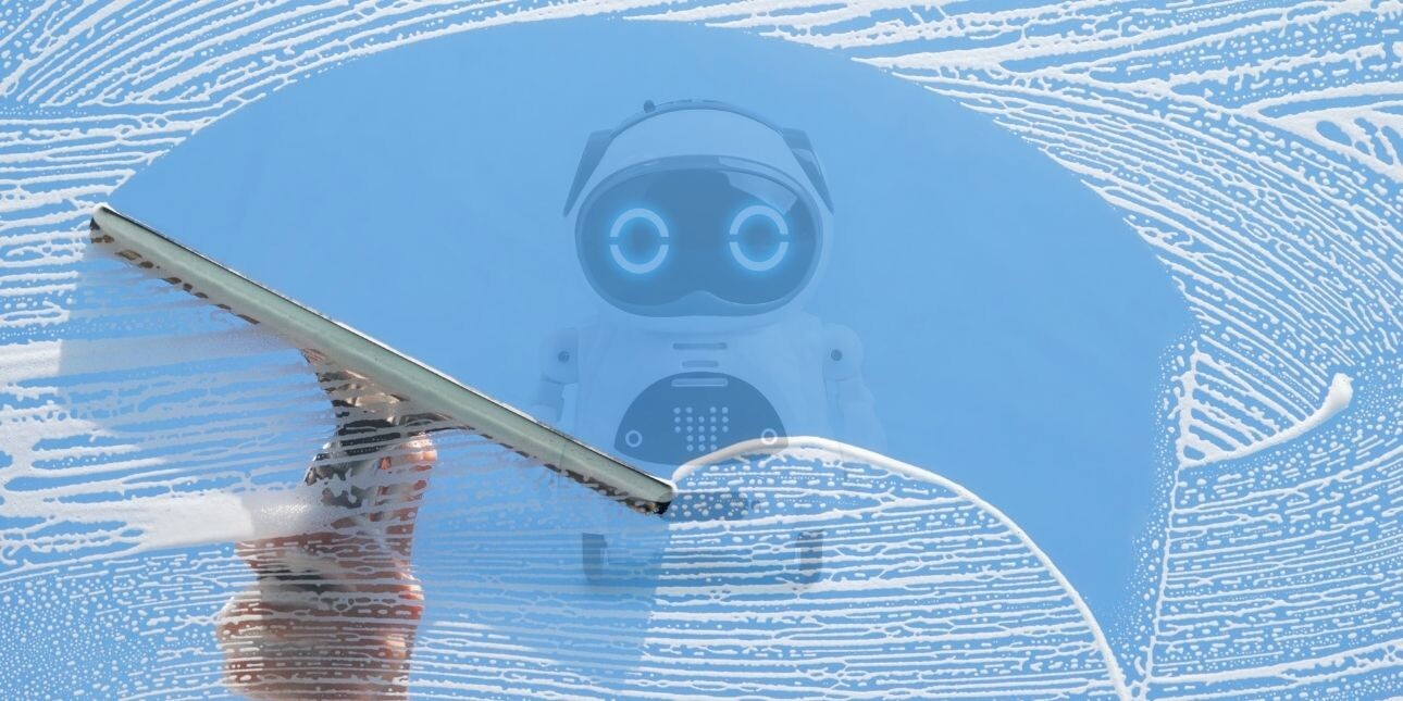 A window squeegee creates a clear arched path across a soapy window frame, revealing a small curved robot on wheels.