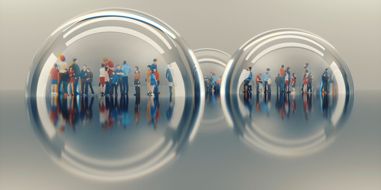 A selection of miniature figures under three glass domes on a grey background.