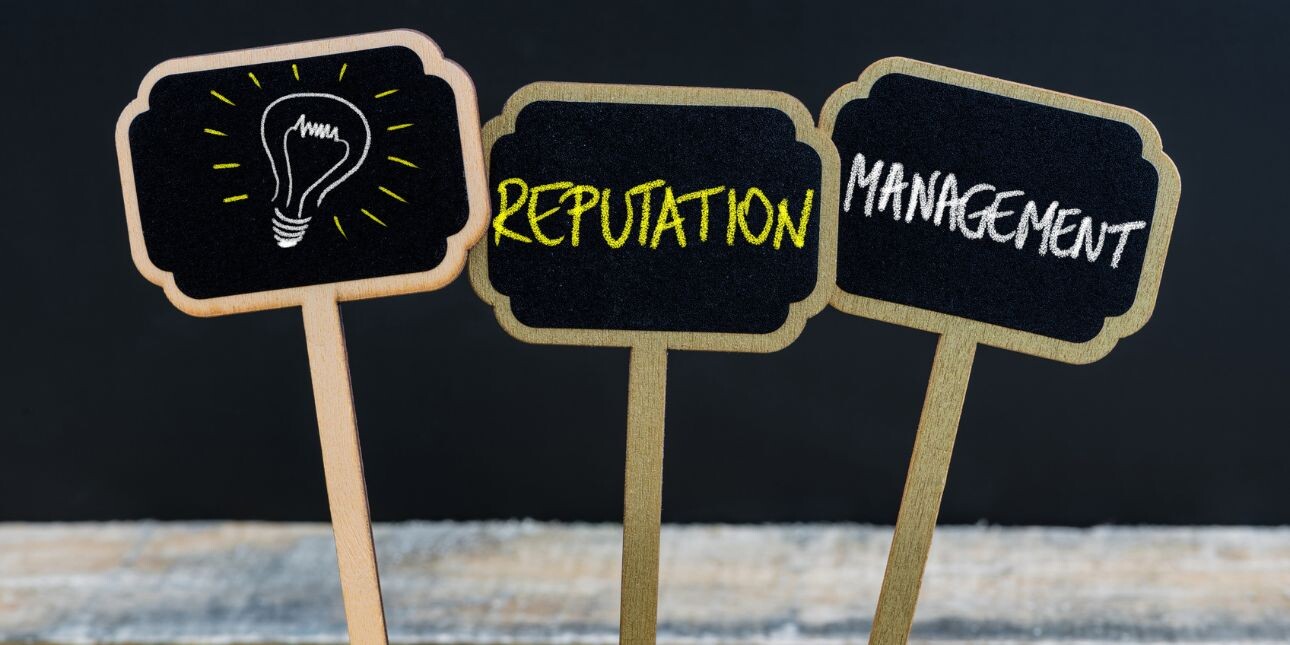 Three chalkboard signs in a row featuring a lightbulb illustration and the words reputation and management