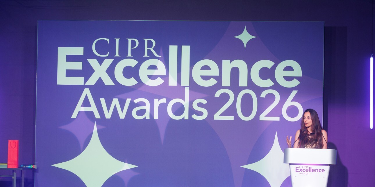 A woman (Farzana Baduel) stood behind a lectern on the right of a stage bathed in purple light. A banner reads CIPR Excellence Awards 2026.