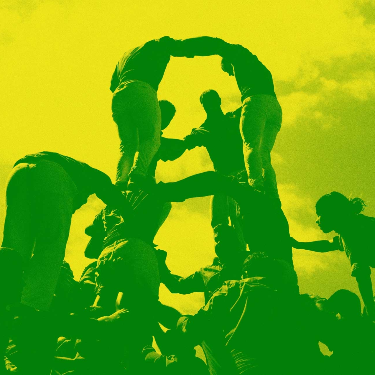 Group of people climbing onto each other shoulders to make a human structure.