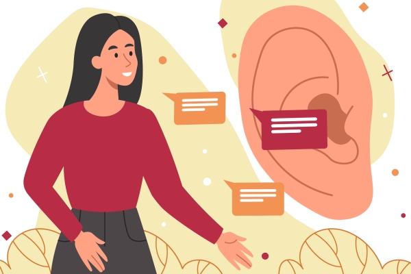 An illustration of a smiling woman with pink skin, long dark hair, red top and dark grey skirt speaking into a life size ear. Her speech is represented by three speech bubbles. She is surrounded by a yellow glow on a white background