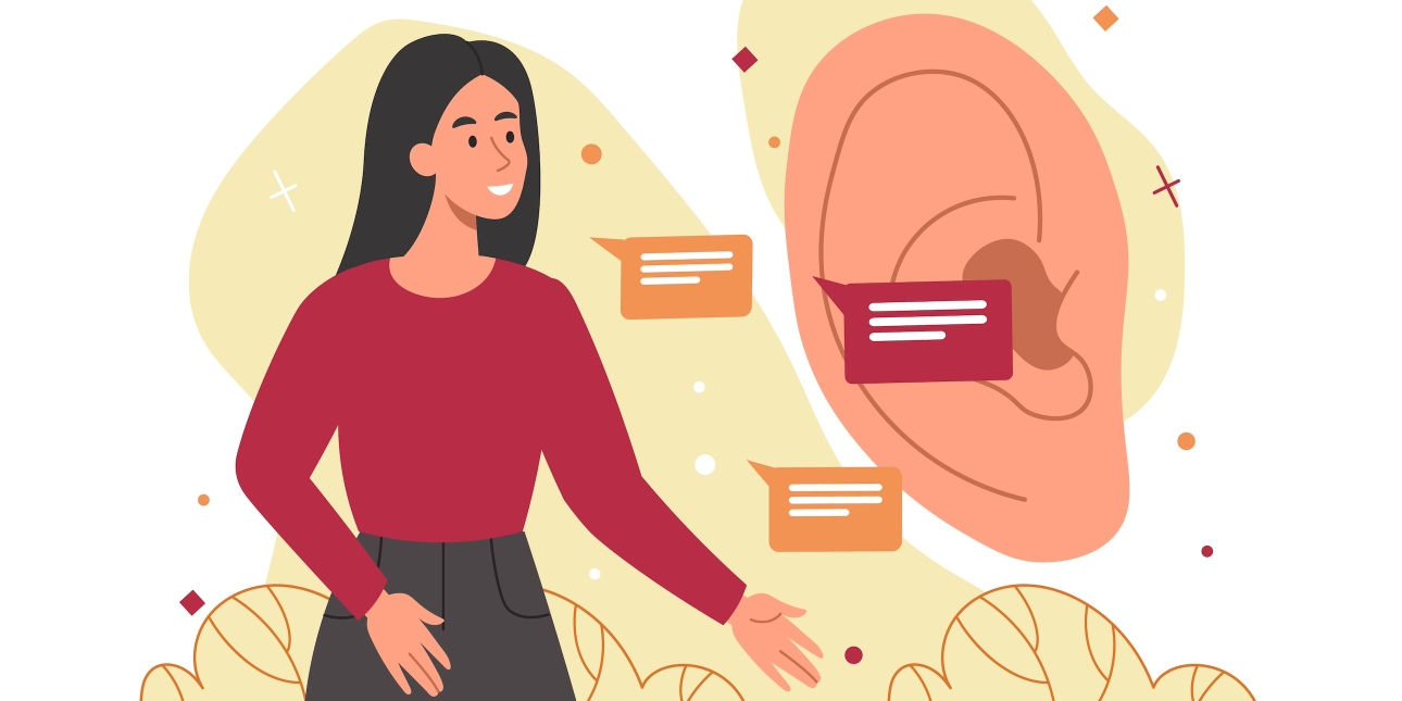 An illustration of a smiling woman with pink skin, long dark hair, red top and dark grey skirt speaking into a life size ear. Her speech is represented by three speech bubbles. She is surrounded by a yellow glow on a white background