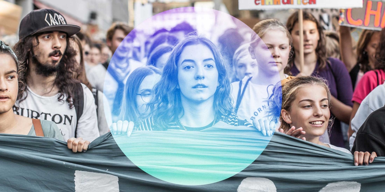 Young people holding a banner taking part in a protest