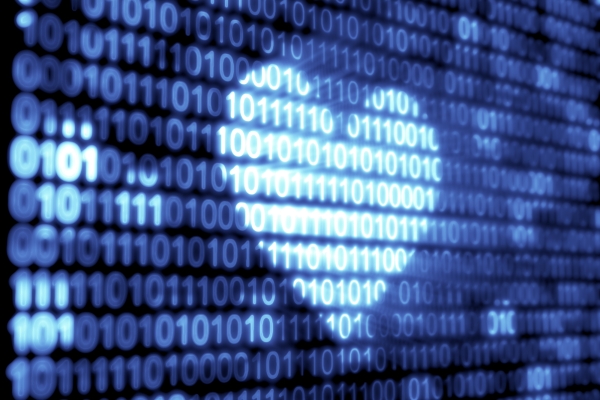 A heart shaped light is cast on a digital image composed of lines of random sequences of zeros and ones in different shads of blue on a black background