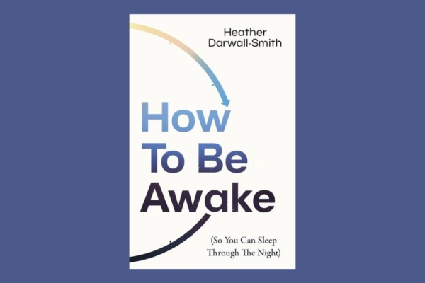 A white book with 'How To Be Awake' written on the cover in blue with the writers credit