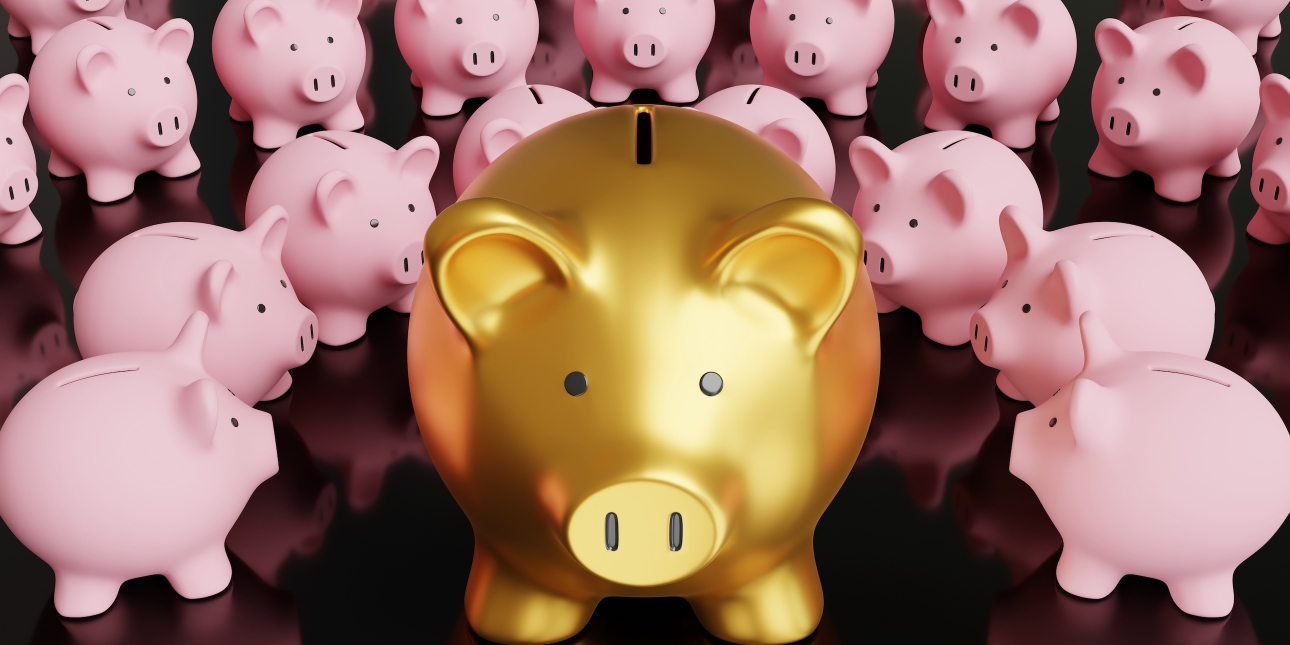 A large gold piggy bank surrounded by more than a dozen smaller pink piggy banks