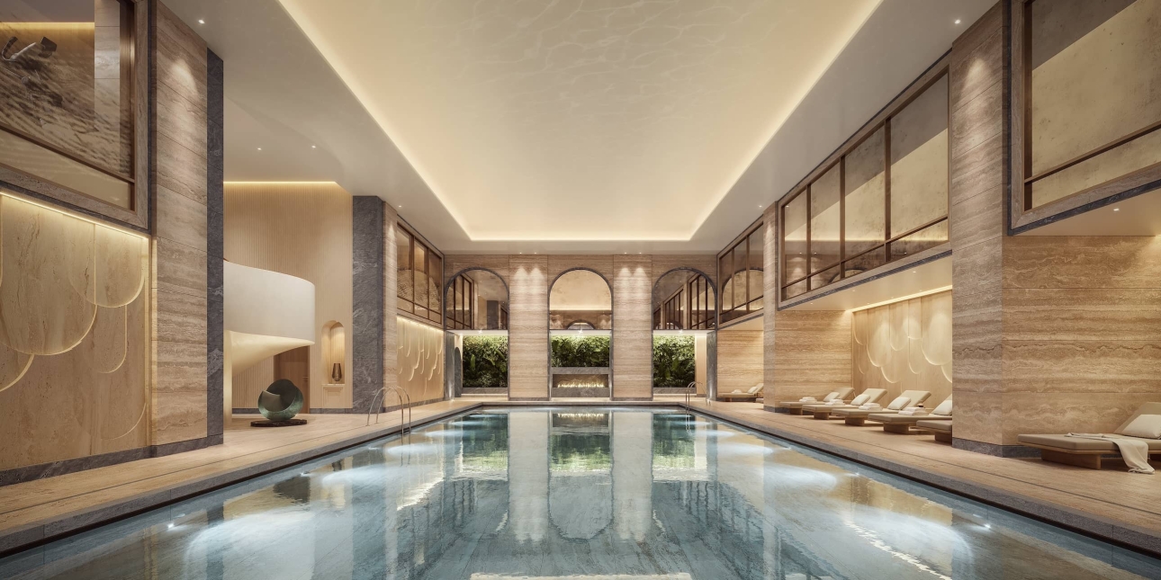 The interior of the sumptuous OWO swimming pool, with marble interior, arches and loungers reflecting in the water