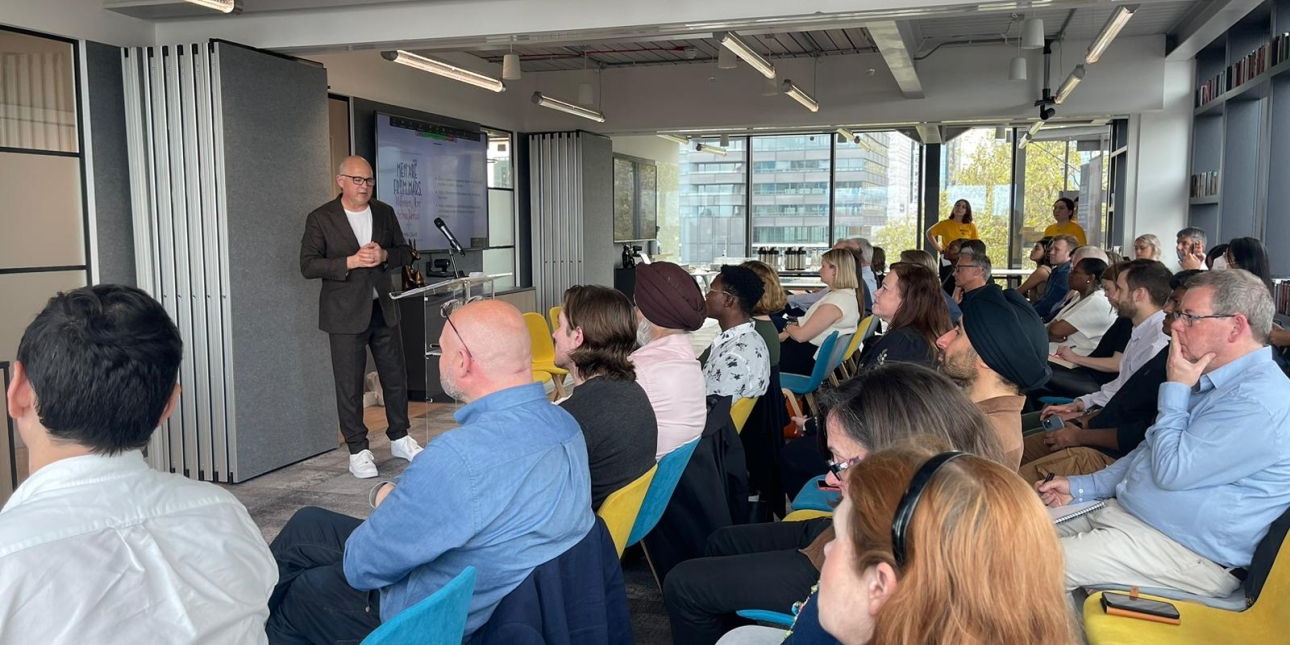 Stephen Waddington on stage giving a speech to an audience of more than 20 people