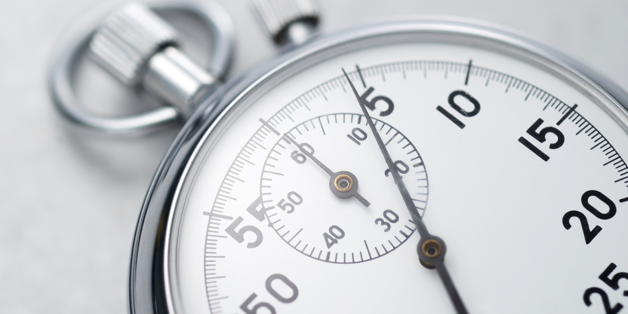 A segment of a chrome analogue stopwatch. The second hand is pointing to four seconds on the dial.