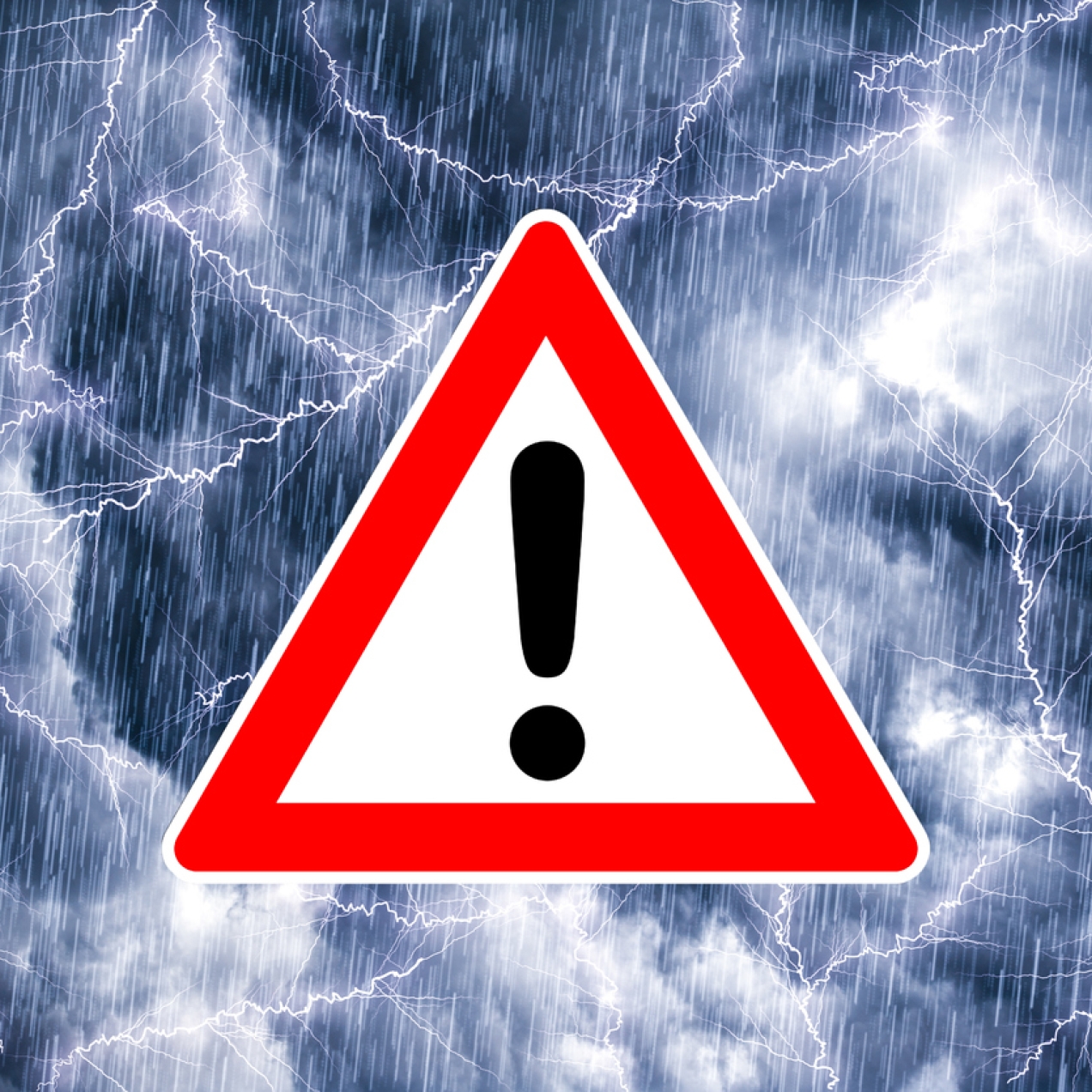 A red warning sign consisting of a black exclamation mark inside a red-bordered white triangle, against a stormy sky