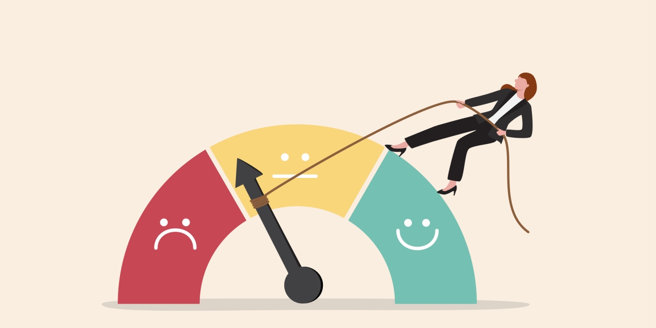 Illustration of a woman holding a rope to move a dial on a meter. The meter is a semi circle with three sections: red with an unhappy face, yellow with a neutral face and green with a happy face. The dial is pointing to the low neutral area of the me