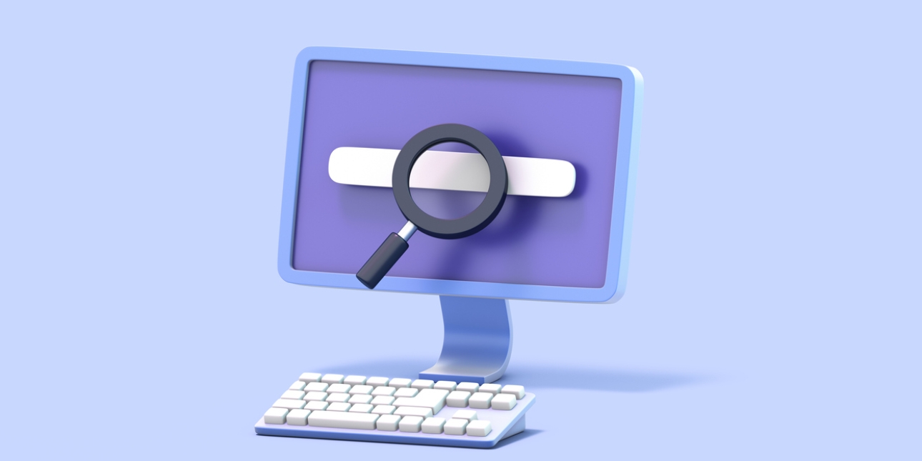 Illustration of a computer monitor and a keyboard. On the screen is a search bar and hovering over the monitor is a magnifying glass