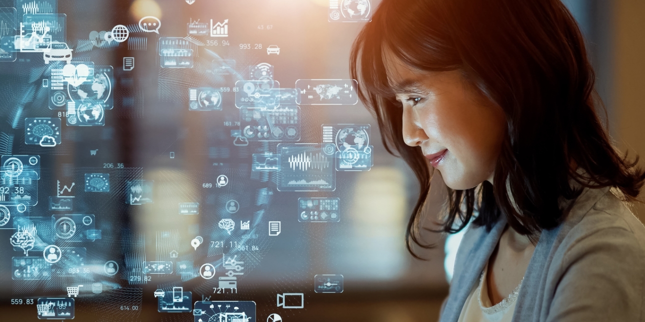 A side profile of a woman's face looking at computer generated icons including share prices, cars, globes, hearts and shopping trolleys