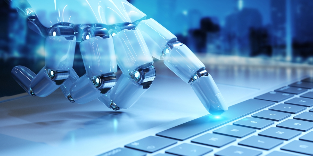 A finger from a robotic hand touches the space bar on keyboard