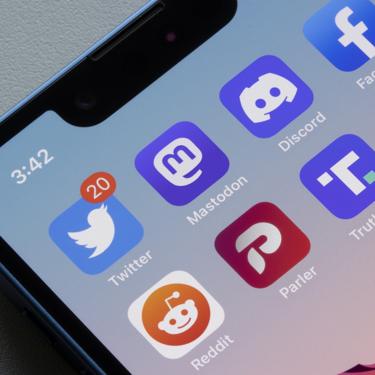 A smartphone screen showing a selection of social media app icons including Twitter and Mastodon