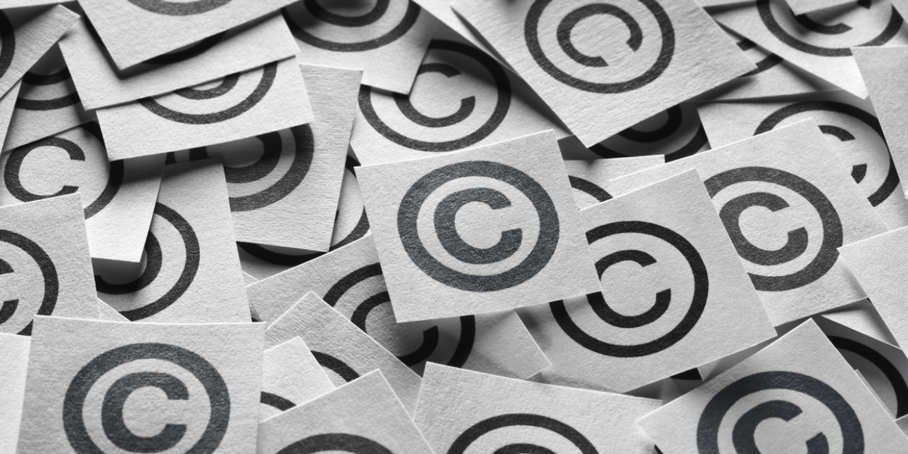 Black and white image showing dozens of square post-it notes, each featuring a printed copyright symbols. These consist of the letter c inside the outline of circle.