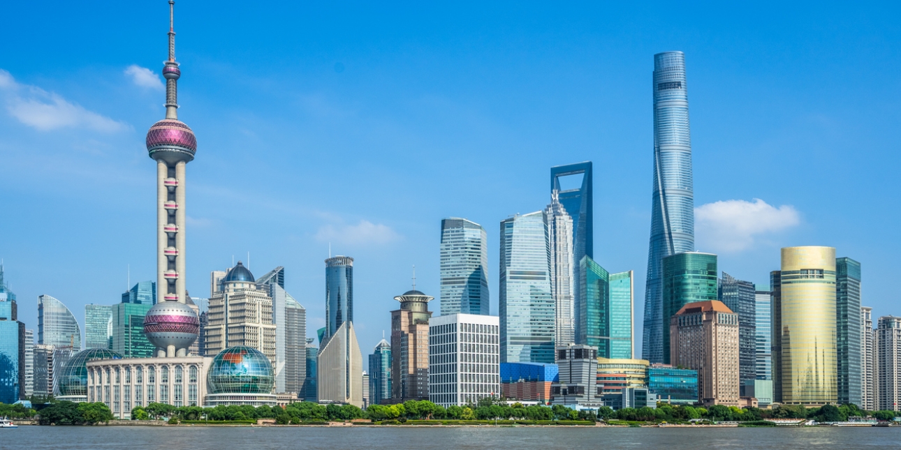 The Shanghai skyline on a bright day day with a blue sky
