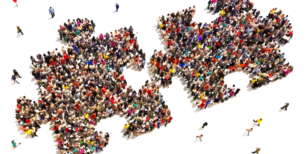 Illustration of two jigsaw piece shapes viewed from above. The shapes are formed by dozens of people with other people walking towards the pieces