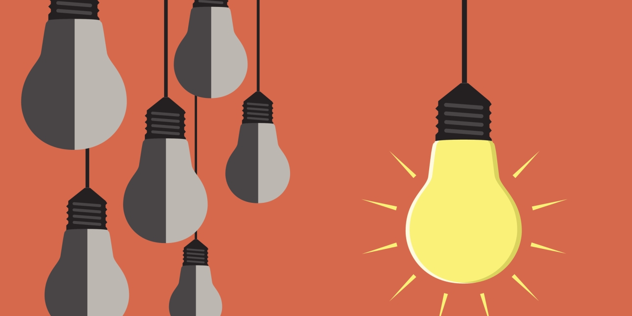 Illustration of six hanging lightbulbs. The five on the left of the picture are two-tone grey. The lightbulb on the right is bright yellow and surrounding by triangles which suggest it is glowing. The background is orange.