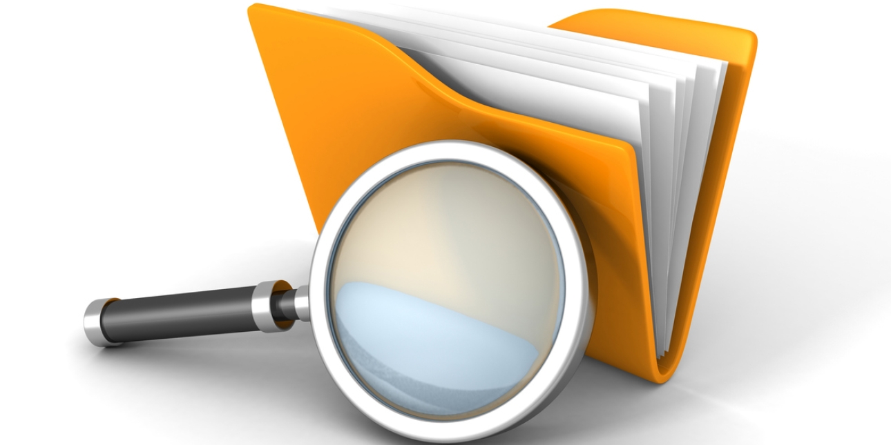 Computer generated image of a magnifying glass next to an orange folder of paperwork