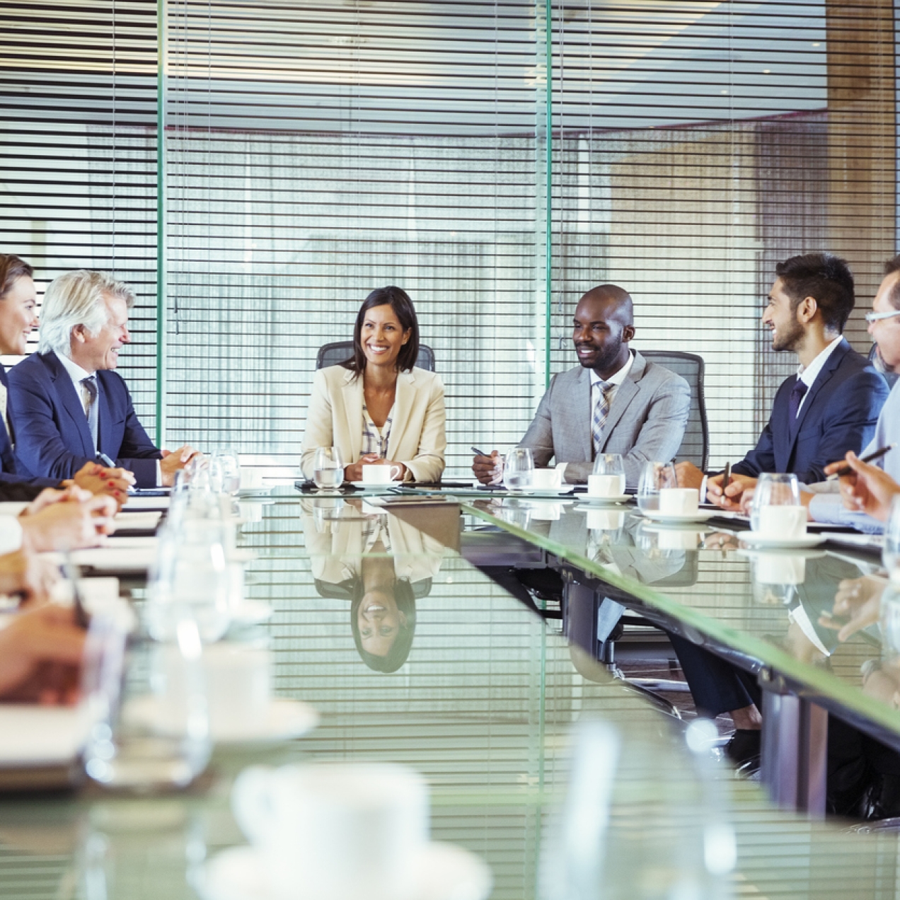Eleven businesspeople sat around a board table.