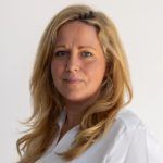 A colour portrait of Ella Davidson. Ella is a white woman with long blond hair.