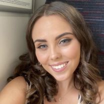 A portrait of Jessica Gaynor. Jessica is a white woman with shoulder length brown hair.