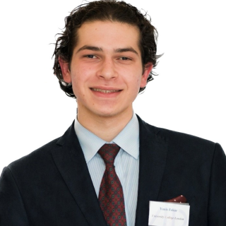 A head and shoulders photo of Yanis Fekar looking at the camera and smiling.