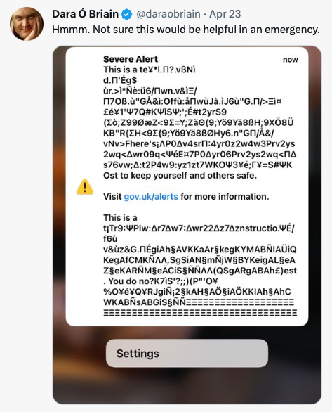 Screenshot of a tweet by Dara Ó Briain. He writes: 'Hmmm. Not sure this would be helpful in an emergency.' It is accompanied by a screenshot of his mobile phone screen with the headline Severe Alert and random characters.