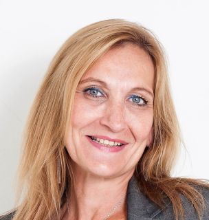 Head shot of Sabine Raabe looking at the camera and smiling