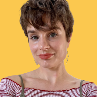 Head shot of Emily Horton, a white woman, with short brown hair. She is looking at the camera and smiling.