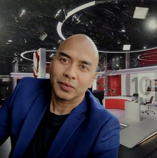 Sagar Sharma stood in front of the BBC News at 10 television studio