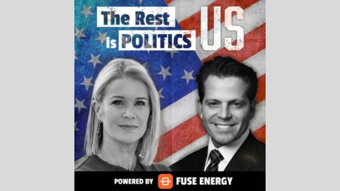 On the background of a US flag are the words The Rest is Politics US and black and white portraits of the the hosts: Katty Kay is a white woman with blonde hair; Anthony Scaramucci is a white man with short dark hair