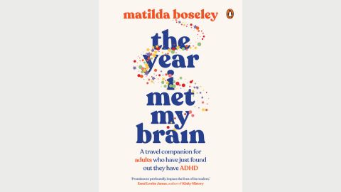White book cover of 'the year i met my brain' in blue in lower text with other text on the page