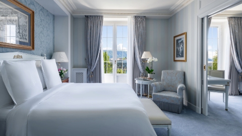 The pastel blue interior of the executive suite with matching walls, upholstery and bedding, plus double doors with a view of the mountains.