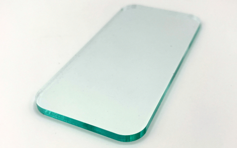 A mobile phone shaped piece of clear acrylic on a white background.